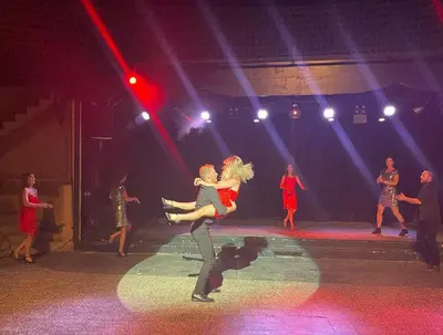 a group of people dancing on a stage at Kallisterra in Sainte-Lucie de Porto-Vecchio