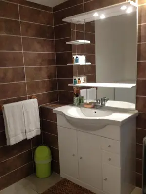 a bathroom with a sink and a mirror at Camping U STABIACCIU in Porto-Vecchio