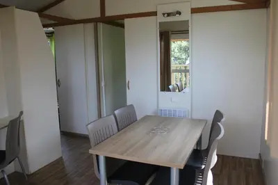 a dining room with a wooden table and chairs at Les Hauts de Torraccia in Cargèse