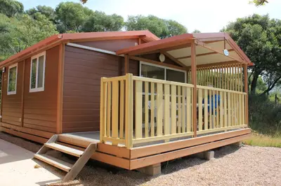 a wooden cabin with a porch and a staircase at Les Hauts de Torraccia in Cargèse
