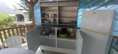 a kitchen with a white refrigerator in a room at Perula di Machja in Alata