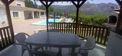 a blue table and chairs on a balcony with a pool at Perula di Machja in Alata
