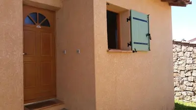 a building with a door and a window on it at Maison Alba Rossa 56 in Serra-di-Ferro