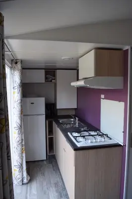a kitchen with a sink and a stove top oven at Camping Paradella in Calenzana