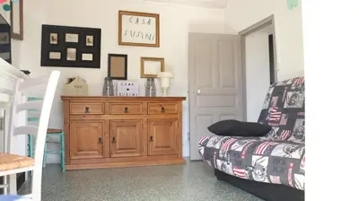 a living room with a couch and a dresser at Casa Susini in Pianottoli-Caldarello