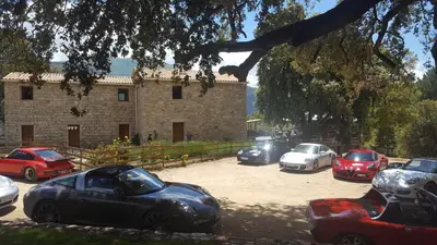 a group of cars parked in front of a building at Maison d'Hôtes Zella in Bains de Guitera