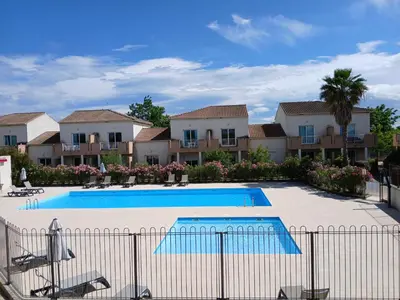 a swimming pool in front of a villa at Terres de France - Les Hauts du Maquis in Linguizzetta
