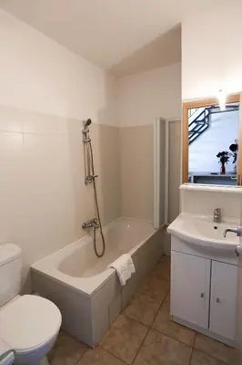 a bathroom with a tub and a toilet and a sink at Terres de France - Les Hauts du Maquis in Linguizzetta