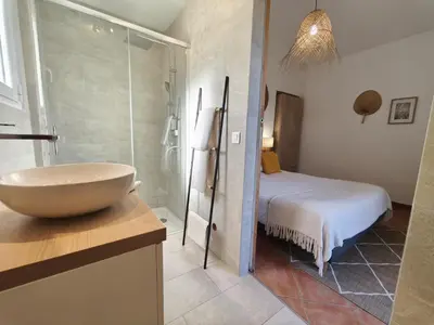 a bathroom with a sink and a bed in a room at Chambres Isula Bella in Figari