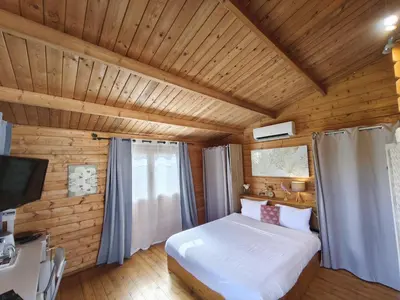 a bedroom with a bed in a wooden room at Chambres Isula Bella in Figari