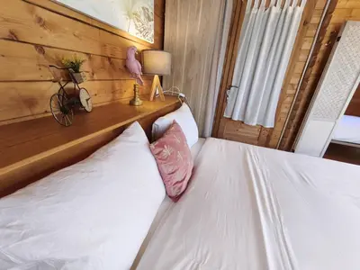 a bedroom with a bed with two white pillows at Chambres Isula Bella in Figari
