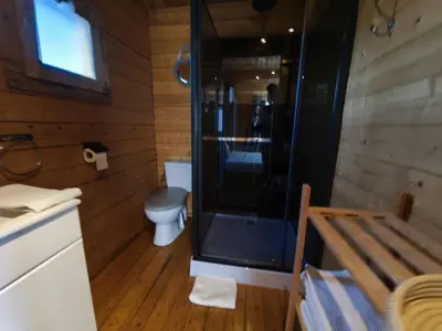 a bathroom with a toilet and a glass shower at Chambres Isula Bella in Figari