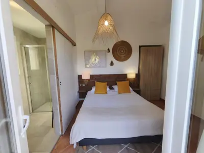 a bedroom with a bed with yellow pillows at Chambres Isula Bella in Figari