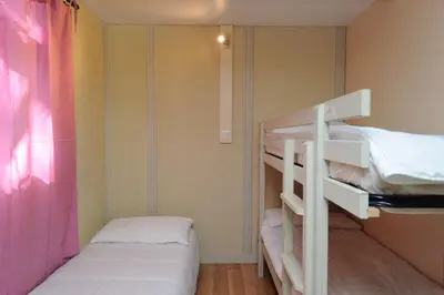a couple of bunk beds in a room at CAMPING LES ILOTS D'OR in Porto-Vecchio