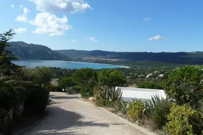 a road with a view of a body of water at Bellavistaloc' in Porto-Vecchio