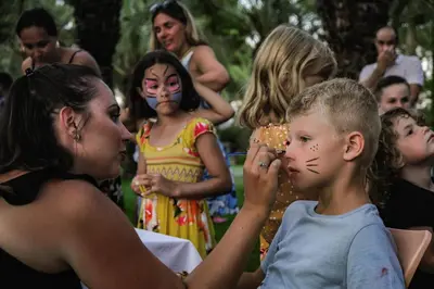 a young boy getting his face painted at a party at Belambra Clubs Borgo - Pineto in Borgo