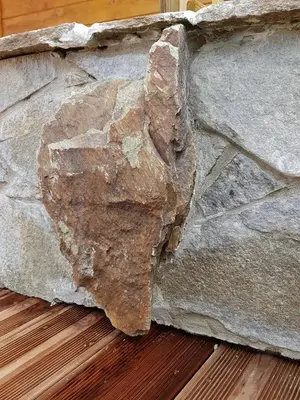 a large rock on the side of a stone wall at Le Chalet de Valentine & Laurent in Olmiccia