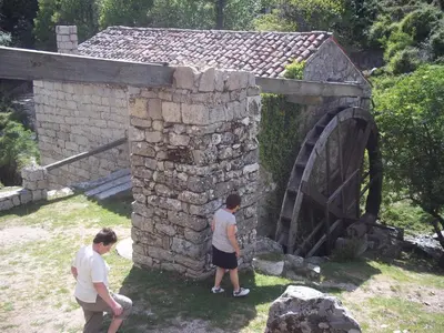 two people standing in front of a stone bridge at Le Chalet de Valentine & Laurent in Olmiccia