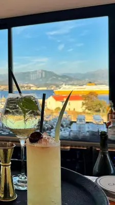 a dining room with a table with a view of the ocean at Hotel San Carlu Citadelle Ajaccio in Ajaccio