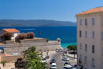 a kitchen with a bar with a view at Hotel San Carlu Citadelle Ajaccio in Ajaccio