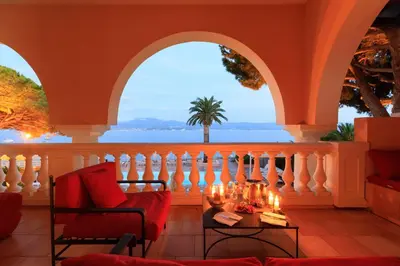 a room with a balcony with a view of the ocean at Hôtel Les Mouettes - Teritoria in Ajaccio