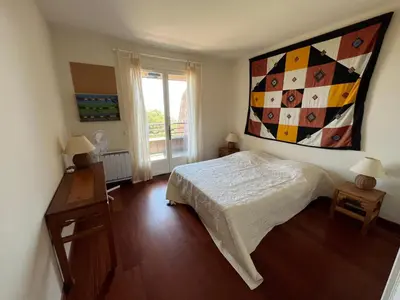 a bedroom with a bed and a painting on the wall at Maison En Pierre Corse Vue Mer in Sari Solenzara