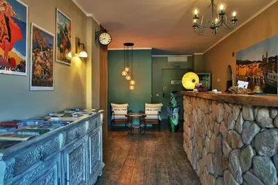 a bar in a restaurant with a stone wall at Hotel du Pont de l'Oso in Cala Rossa