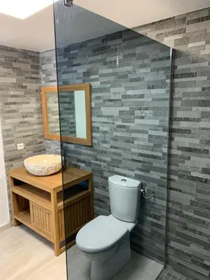 a bathroom with a toilet and a sink at Hôtel Castel d'Orcino in Calcatoggio