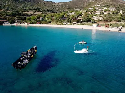 two boats in the water next to a beach at Hôtel-Restaurant Marina Di Lava - Grand Ajaccio in Appietto