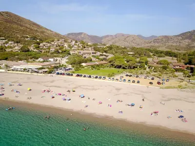 an aerial view of a beach with people and umbrellas at Hôtel-Restaurant Marina Di Lava - Grand Ajaccio in Appietto