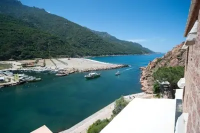 a view of a body of water with boats in it at Hôtel & Restaurant Le Belvédère in Porto Ota