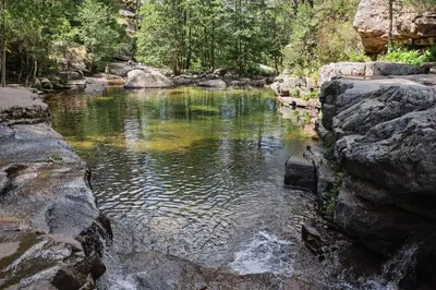 a pool of water with rocks in a river at Scopa Rossa in Evisa
