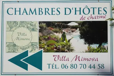 a sign for a resort with a swimming pool at Villa Mimosa in Favone