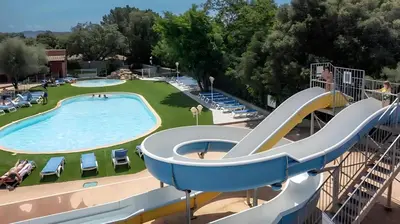 a slide in a swimming pool at a resort at Camping Acqua E Sole in Sainte-Lucie de Porto-Vecchio