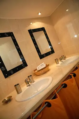 a bathroom with a sink and a mirror at Camping Acqua E Sole in Sainte-Lucie de Porto-Vecchio