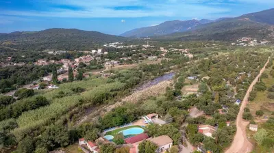 an aerial view of a village in the mountains at Camping Acqua E Sole in Sainte-Lucie de Porto-Vecchio