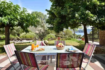 a table with a bowl of fruit on top of it at U Casinu in Piana
