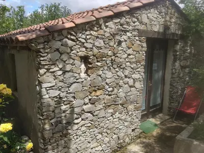 a stone building with a window and a door at Villa Praesidio in Riventosa