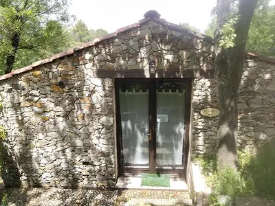 a stone building with a large glass door at Villa Praesidio in Riventosa