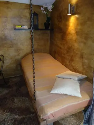 a swing bed in a room with a pillow at Villa Praesidio in Riventosa