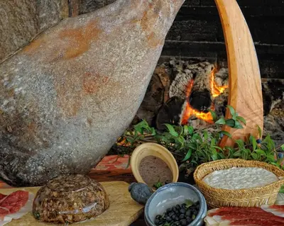 a fireplace with bread and a fire in it at Auberge U Licettu in Cuttoli-Corticchiato