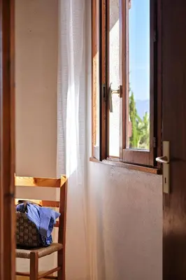 an open door to a room with a window at Motel de Porticcio in Porticcio