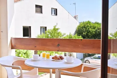a table with a plate of food on a balcony at Motel de Porticcio in Porticcio