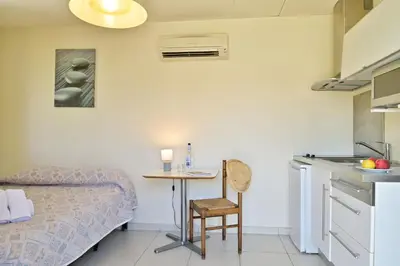 a room with a bed and a table in a room at Isula Bianca in Porticcio