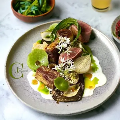 a plate of food with meat and vegetables on a table at Hotel Costa Salina in Porto-Vecchio