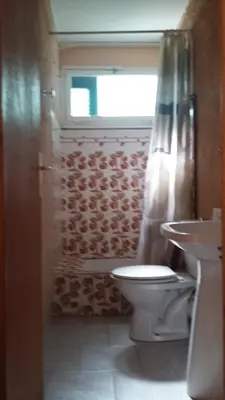 a bathroom with a toilet and a sink and a window at Camping Europa Beach in Castellare-di-Casinca