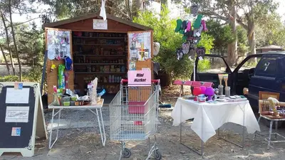 a book stand with a table and a shopping cart at Camping Europa Beach in Castellare-di-Casinca