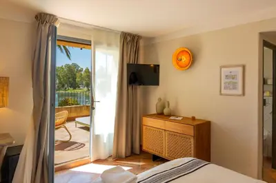 a bedroom with a bed and a sliding glass door at Casa Santini x Roc Seven in Porto-Vecchio