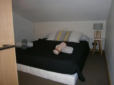 a bedroom with a bed with black sheets and pillows at U Palazzinu in Porto-Vecchio