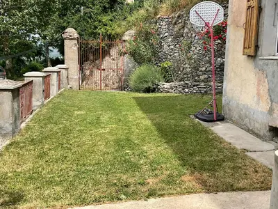 a yard with a tennis racket in the grass at Casa Defranchi in Sant Andrea di Bozio